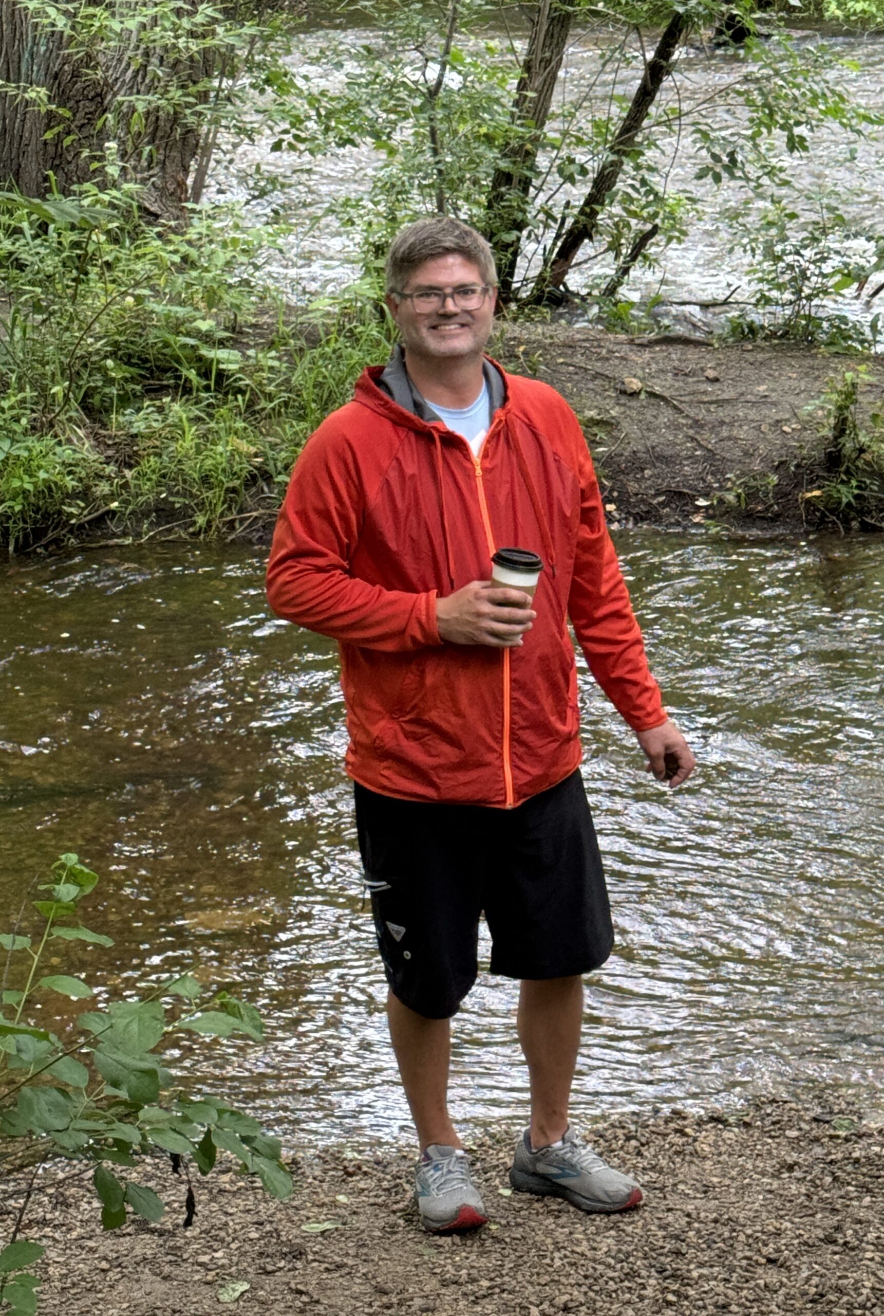 Image of Jake Bic standing by a river.